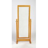 Mouseman - an oak cheval mirror, the rectangular mirror plate supported on octagonal columns and