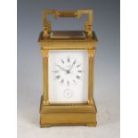 A late 19th/ early 20th century carriage clock T.SHAW, GLASGOW, the white enamel dial with