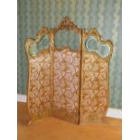 A late 19th/early 20th century Rococo style gilt wood three fold screen, each panel with scroll,