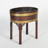 A George III mahogany and brass bound oval wine cooler, with lead lined interior and brass drop