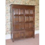 An oak wardrobe by repute made from old panelling of the home of Henry VIII, formerly in St. Johns