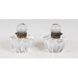A pair of late 19th century gilt metal mounted clear glass inkwells, of tapered lobbed form, 7cm