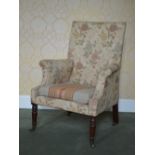 A 19th century mahogany armchair, the rectangular upholstered back and scroll arms raised on tapered