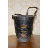 A 19th century leather fire bucket with brass studded detail and leather strap handle, black painted