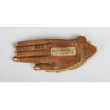 Antiquities- An Ancient Egyptian sarcophagus fragment in the form of a hand, carved and painted