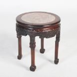 A Chinese dark wood jardiniere stand, Qing Dynasty, the circular top with mottled red and white