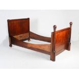 A 19th century Continental mahogany and gilt metal mounted Empire style single bed, the foot board
