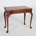 A George III mahogany concertina action card table, the hinged rectangular top opening to a green