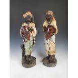 A pair of late 19th century Continental cold painted terracotta figures of male and female water