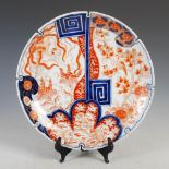 A late 19th/early 20th century Japanese Imari porcelain dish, with asymmetric decoration of birds