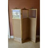 A late 19th/early 20th century gilt wood three fold screen, each panel with ribbon tied surmount and