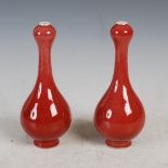 A pair of Chinese porcelain sang-de-boeuf glazed garlic neck bottle vases, late 19th/ early 20th