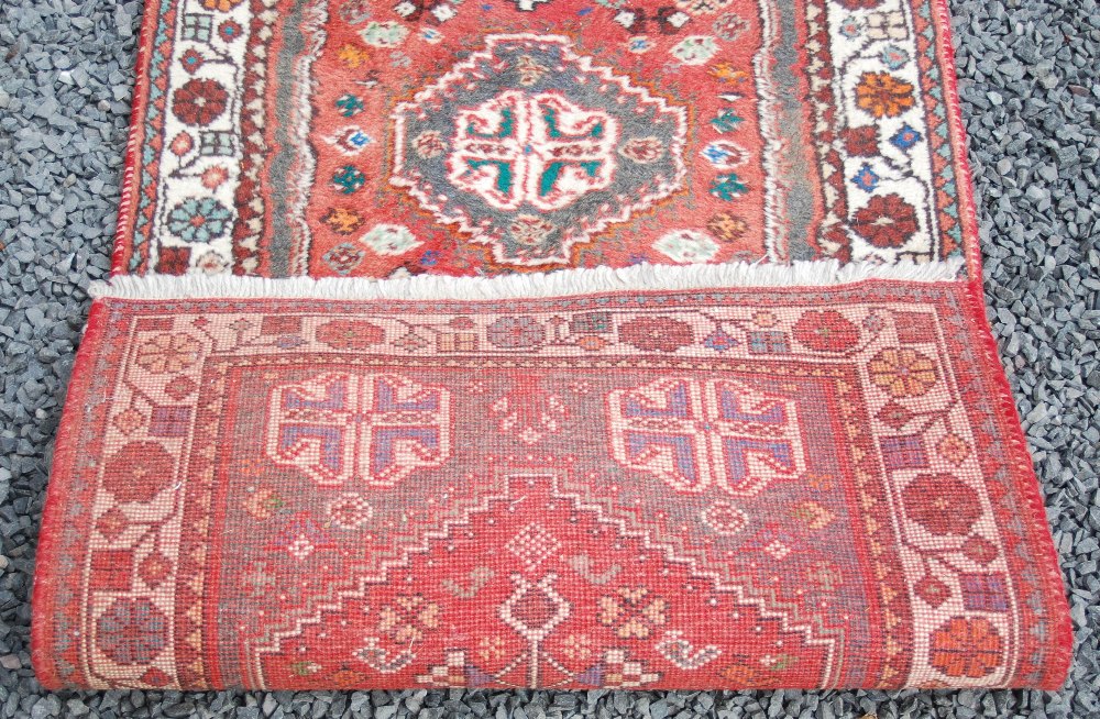 A Persian runner, 20th century, the rectangular madder ground centred with an octagonal shaped - Image 4 of 4