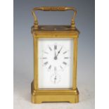 A 19th century brass cased repeater carriage clock with alarm, the white enamel dial with Arabic and