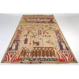 A near pair of early 20th century Egyptian Revival applique wall hangings, decorated with figures
