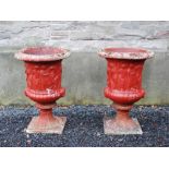 An impressive pair of late 19th century later painted fire clay garden urns, cast in relief with a