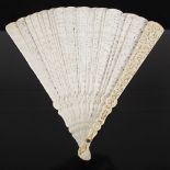 A Chinese Canton ivory fan, Qing Dynasty, the end guards carved with figures, pavilions, and pine