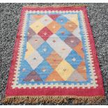 A small Kelim rug, 20th century, the rectangular field with blue, russet, ochre and grey coloured