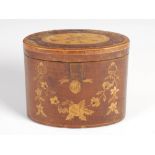 A George III mahogany and marquetry inlaid oval tea caddy, the hinged cover inlaid with a stylised