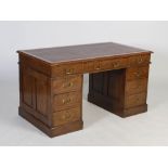 A late 19th century oak pedestal desk, the rectangular top with leatherette skiver above three