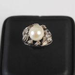 A white metal cultured pearl and diamond cocktail ring, mid 20th century, centred with a cultured