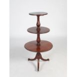 A Victorian mahogany revolving drop leaf graduated three tier whatnot, raised on four downswept