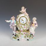 A late 19th/ early 20th century German flower encrusted porcelain mantle clock, the circular dial