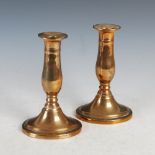 A pair of George III brass ejector candlesticks, on oval bases with incised line detail, 18cm high.