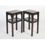 A pair of Chinese dark wood jardiniere stands, Qing Dynasty, the rectangular panelled tops above