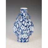 A Chinese porcelain blue and white pilgrim vase, Qing Dynasty, the blue ground decorated with prunus