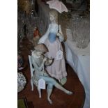 TWO LLADRO FIGURINES, ONE OF A GIRL SITTING PLAYING MUSICAL INSTRUMENT AND THE OTHER OF A LADY