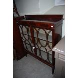 EARLY 20TH CENTURY MAHOGANY TWO DOOR DISPLAY CABINET WITH GLAZED ASTRAGAL DOORS, SUPPORTED ON SQUARE