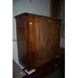 A 19TH CENTURY WALNUT TWO DOOR CABINET