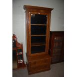 A 19TH CENTURY OAK BOOKCASE/GUN CABINET WITH LARGE GLAZED PANEL DOOR AND TWO FRIEZE DRAWERS