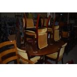 A MID 20TH CENTURY OVAL TEAK DINING TABLE WITH BRASS INLAY, ON CENTRAL COLUMN AND FOUR SPLAYED LEGS,