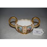 COALPORT TWIN HANDLED PORCELAIN CUP WITH SIX RECTANGULAR HAND PAINTED PANELS DEPICTING ITALIANATE