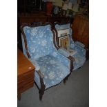 PAIR OF VICTORIAN CARVED MAHOGANY PARLOUR CHAIRS WITH STUFFOVER SEATS AND BACKS, ON BRASS CASTORS