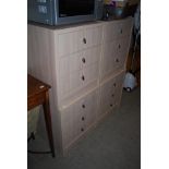 SET OF FOUR SIMULATED LIMED OAK THREE DRAWER BEDSIDE CHESTS