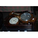 OAK BAROMETER AND A REPRODUCTION MAHOGANY WALL CLOCK