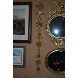 PAIR OF COMPOSITE GILDED GEORGIAN STYLE WALL ORNAMENTATIONS WITH RIBBON TIED SURMOUNTS, SCROLLS