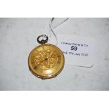 SMALL YELLOW METAL CASED POCKET WATCH WITH FOLIATE ENGRAVED ROMAN NUMERAL DIAL STAMPED 18K