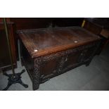 A 19TH CENTURY CARVED OAK COFFER