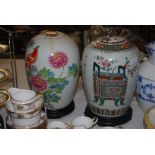 PAIR OF CHINESE JARS AND COVERS DECORATED WITH MIXED FOLIAGE AND EXOTIC BIRDS ON HARDWOOD STANDS,