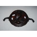 ARTS & CRAFTS MAHOGANY PANEL CARVED IN RELIEF WITH AN OWL STANDING ON A TWIN HANDLED GRECIAN URN,