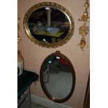 OVAL GILT FRAMED WALL MIRROR, TOGETHER WITH ANOTHER OVAL GILT FRAMED MIRROR WITH LAUREL AND