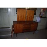 MID 20TH CENTURY TEAK DINING SUITE COMPRISING EXTENDING DINING TABLE WITH THREE ADDITIONAL LEAVES,