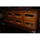 BANK OF EIGHT STAINED PINE CHEMISTS APOTHECARY DRAWERS WITH GLASS HANDLES