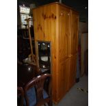 A MODERN PINE TWO DOOR WARDROBE