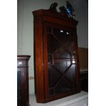 A 19TH CENTURY MAHOGANY HANGING CORNER CABINET WITH GLAZED ASTRAGAL DOOR