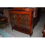 MAHOGANY DISPLAY CABINET WITH GLAZED ASTRAGAL DOORS SUPPORTED ON CABRIOLE LEGS TOGETHER WITH